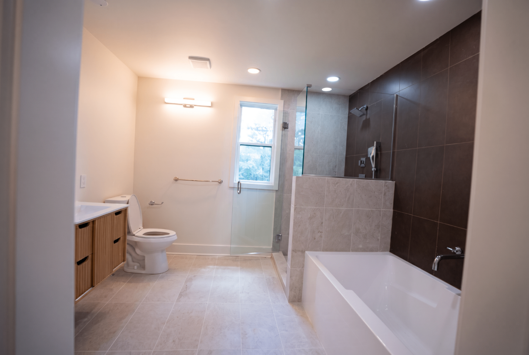 Spa bath with freestanding soaking tub and glass walk-in shower